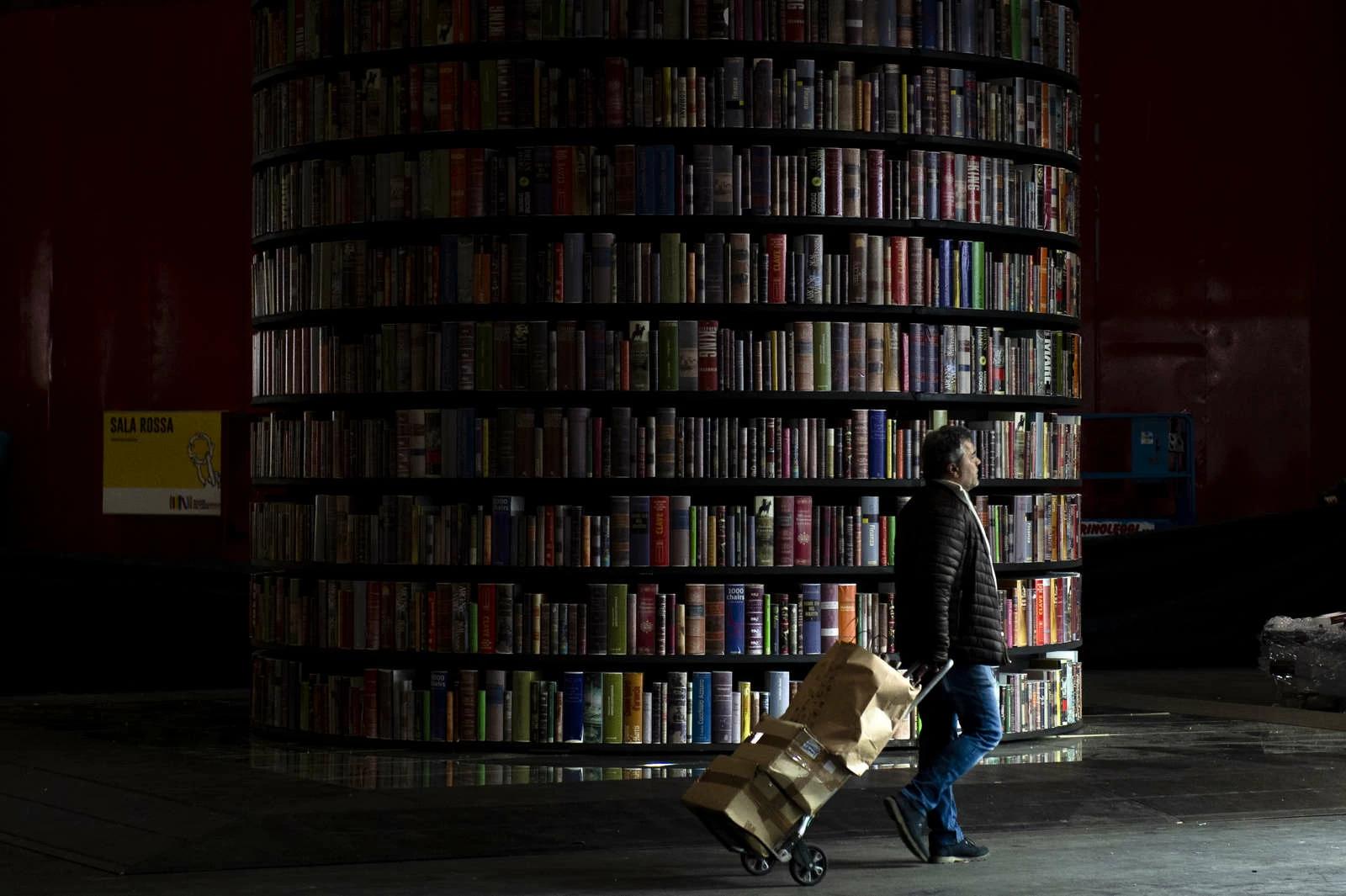 A person walks past Confino Tower during the preparation for the 32nd edition of the Turin International Book Fair. Confino Tower is designed by François Confino and it’s a symbol of the latest editions of the Turin Book Fair.