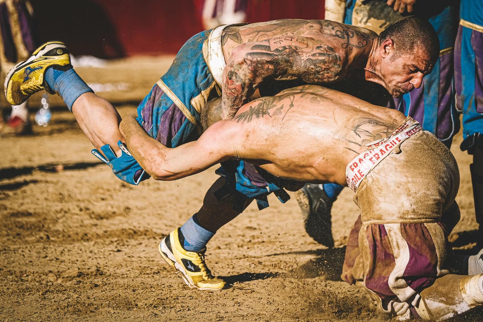 FLORENCE, ITALY – 2019/06/16: Calcio fiorentino (also known as calcio storico “historic football”) is an early form of football and rugby that originated in 16th-century Italy. Once widely played, the sport is thought to have started in the Piazza Santa Croce in Florence. In the photo: The semi final match between Bianchi and Azzuri Teams. Photo and story by Federico Tardito