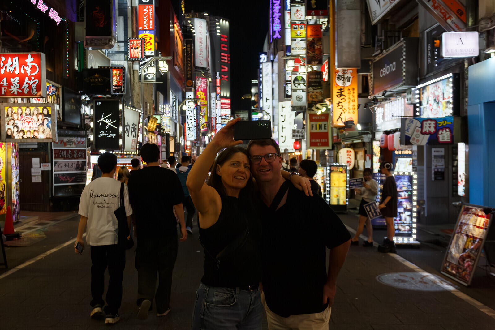A western couple take a selfie with a smartphone in Tokyo's red-light district of Kabukicho,  Shinjuku, Tokyo,Japan. Saturday, September 6th 2025