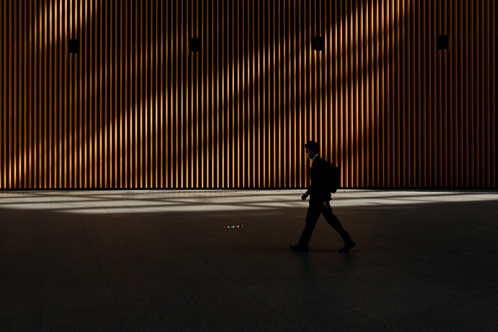 A Japanese salaryman or male office worker walking through the Tokyo International Forum, Yurakucho, Tokyo, Japan. Monday, March 30th, 2026