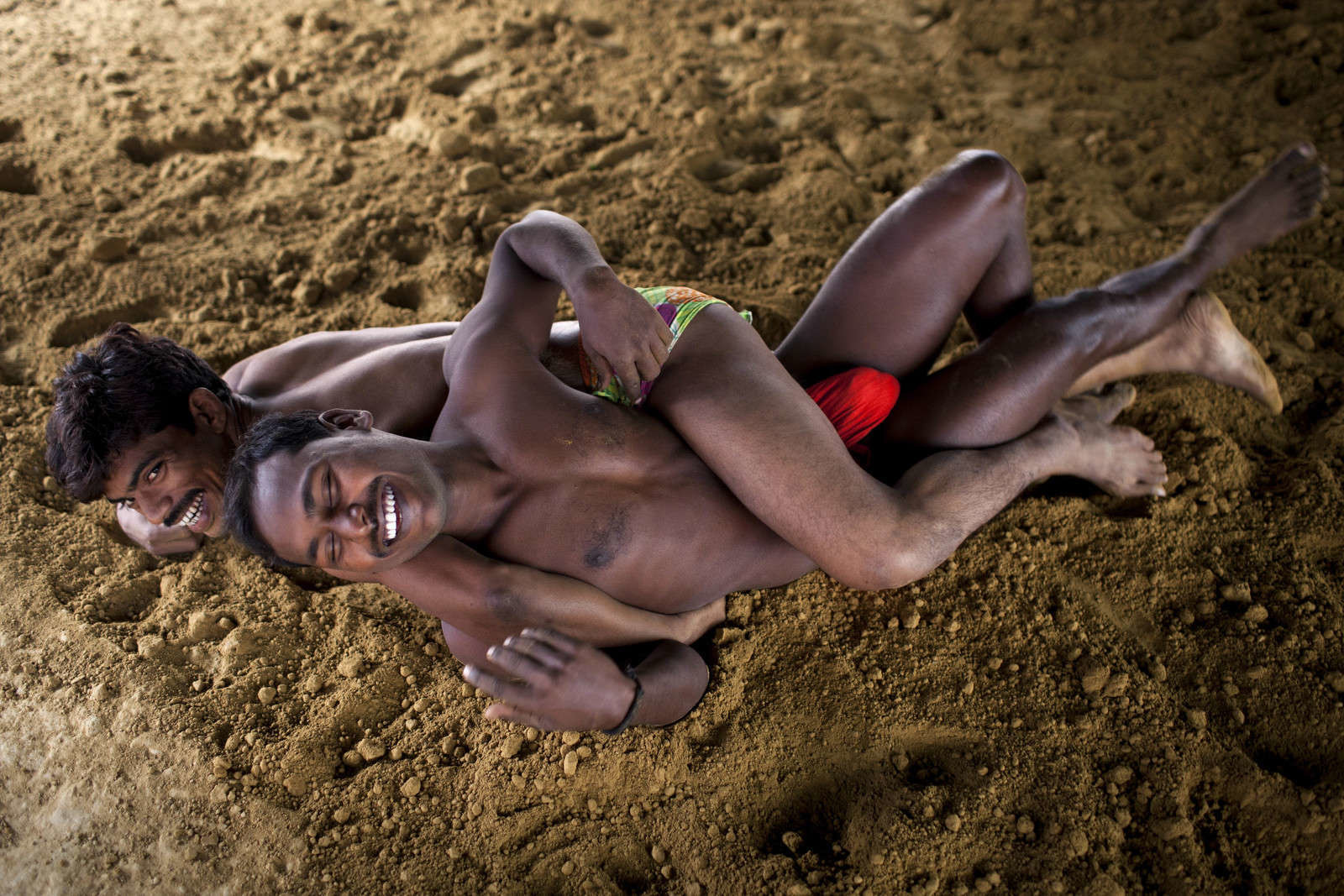 Wrestlers take daily practice in the early morning in Kashi ghat near the Gongha River in Varanasi, India, November 29, 2014. The ancient tradition of Indian wrestling, known as kushti, thrives in Varanasi, one of the world’s oldest cities. Wrestling gyms, or akhara, scattered around the city are of the few places where Hindu men from different casts are considered equals. Now in these days there are not that much mud akhara alive in Varanasi, People are much more interested to play in the mats instead of mud. Varanasi, India.
